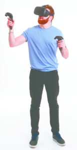 Young bearded man wearing virtual reality device